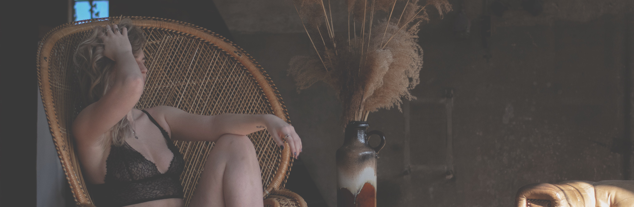 Women sitting in chair in Raw Luxury Lingerie